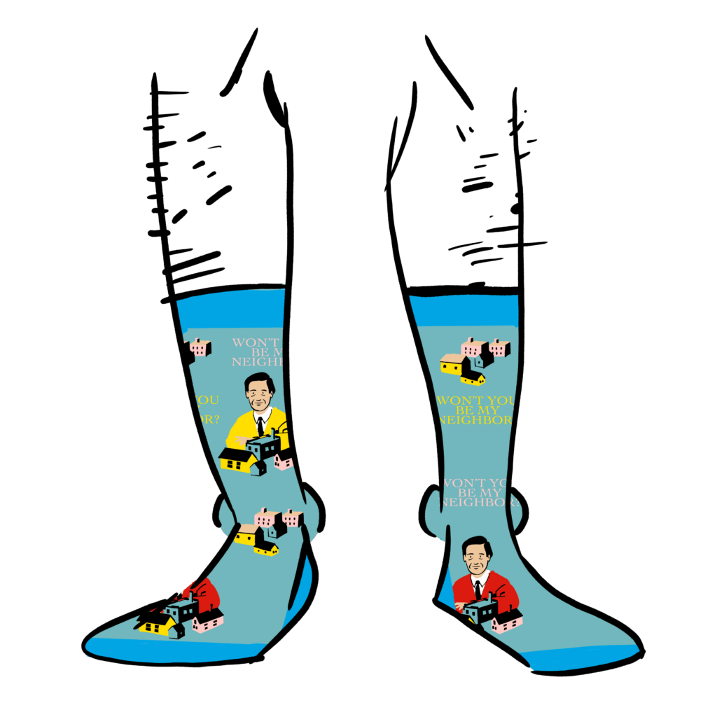 Light blue socks with images of Mister Rogers on them. Text says Won't You Be My Neighbor?