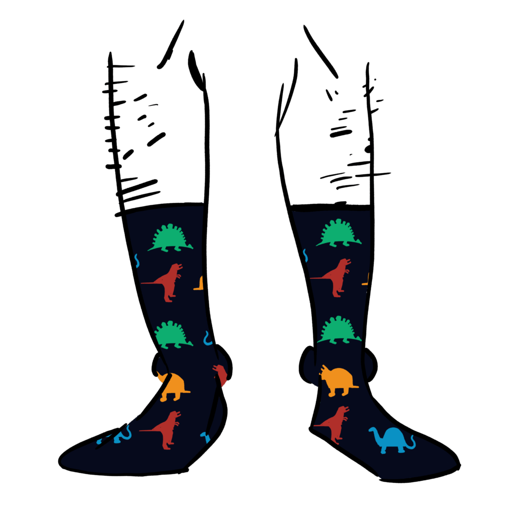 Black socks with illustrations of dinosaurs on them